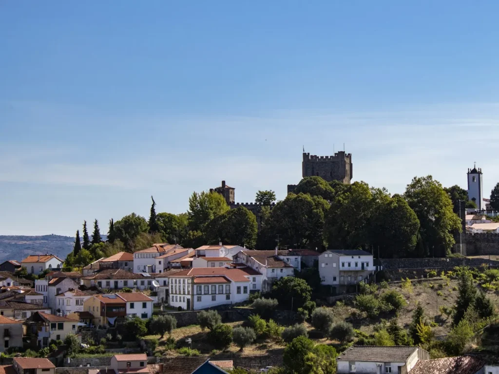 Vila histórica com castelo no topo da colina, serviços de marketing digital em Bragança